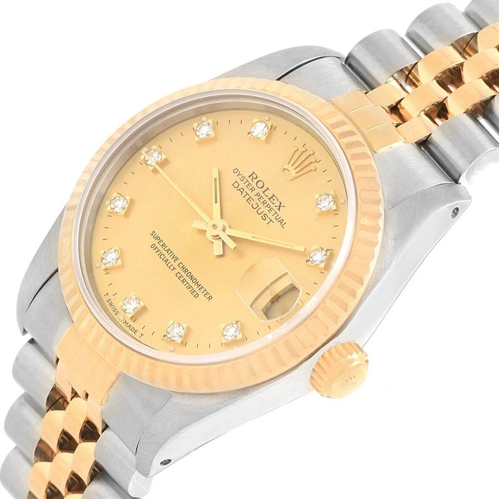 This image shows a front angle of a Mid-Size Rolex Datejust watch, highlighting its gold dial, fluted bezel, and two-tone bracelet.