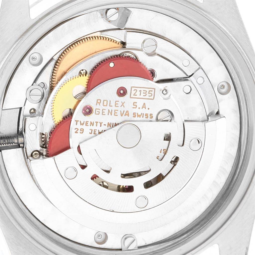 The image shows the internal mechanism of a Rolex Mid-Size 68273 Women's Steel and Gold (two tone) Champagne Dial 68273 Women's Steel and Gold (two tone) Champagne Dial model watch, focusing on the movement and gears.