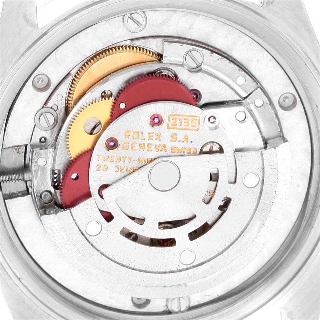 The image shows the internal mechanism of a Rolex Mid-Size 68240 Women's Stainless Steel White Dial 68240 Women's Stainless Steel White Dial model watch, viewed from the back, displaying gears and inscriptions.