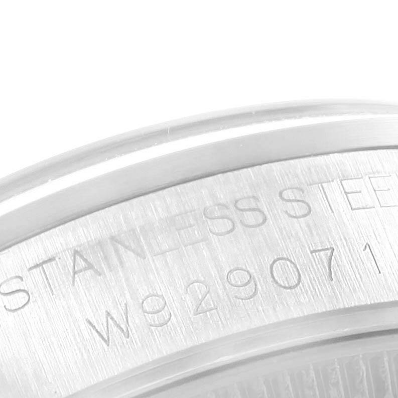 The image shows a close-up of the stainless steel case back of a Mid-Size Rolex watch with part of the serial number visible.