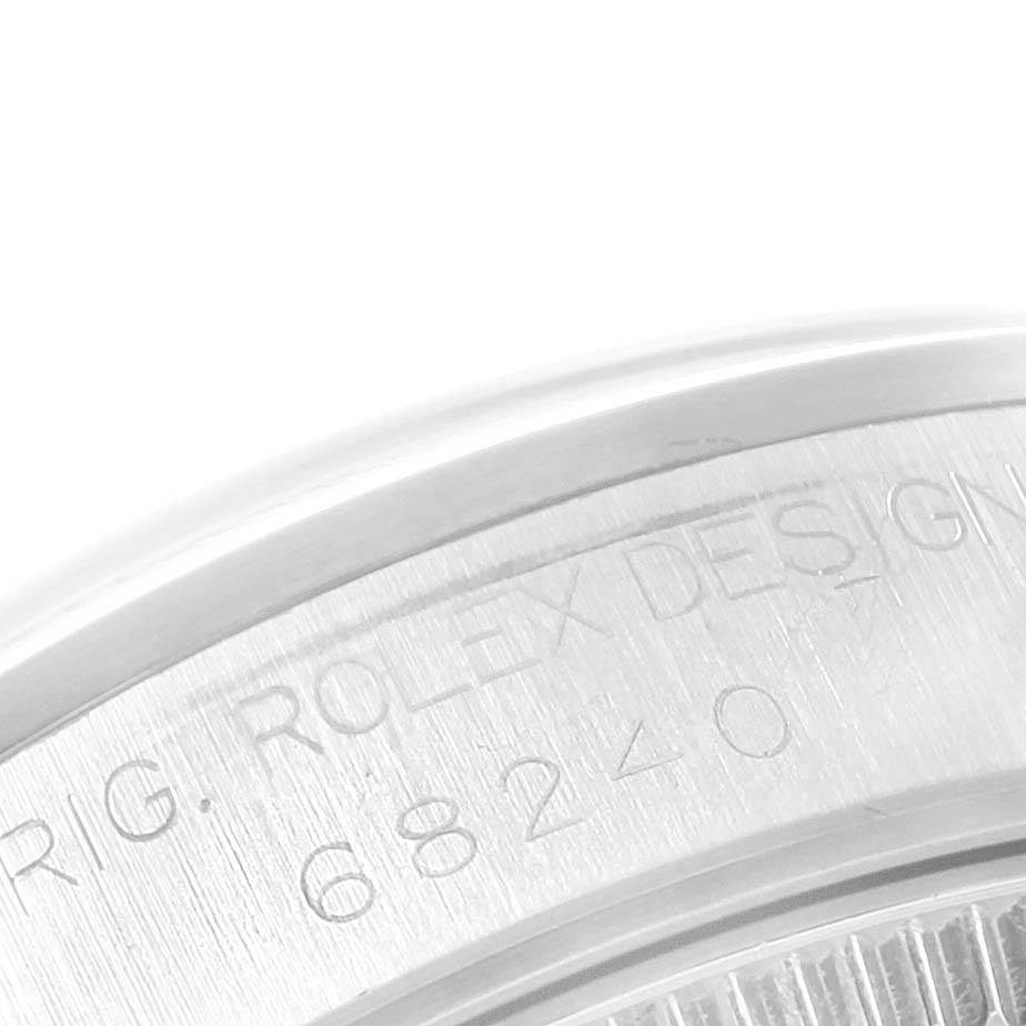 The image shows a close-up of the side and back of a Rolex Mid-Size 68240 Women's Stainless Steel White Dial 68240 Women's Stainless Steel White Dial model, highlighting the engraved text and model number.