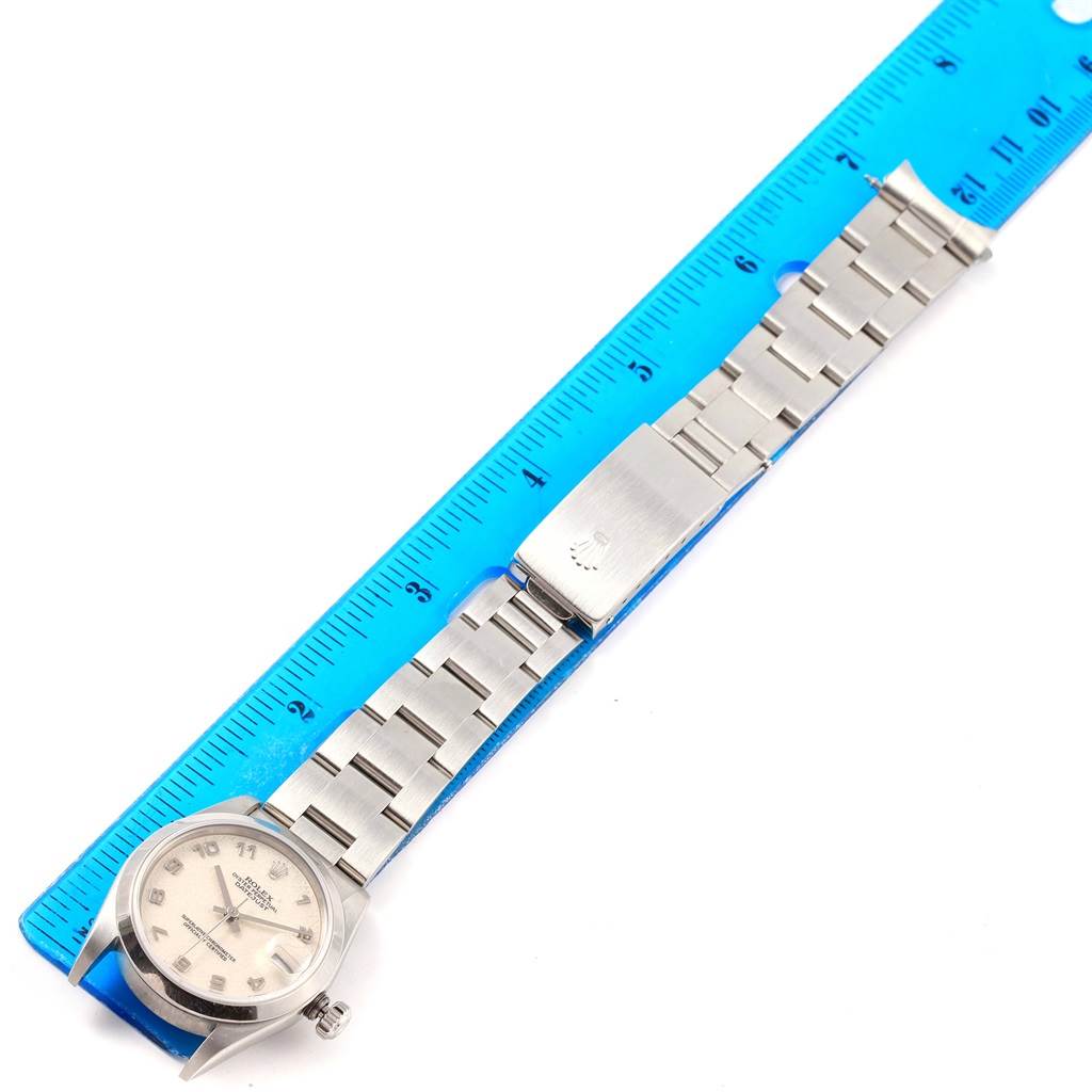 The image shows a Rolex Mid-Size 78240 Women's Stainless Steel Silver Dial 78240 Women's Stainless Steel Silver Dial watch lying flat next to a ruler, displaying the watch face, case, and bracelet.