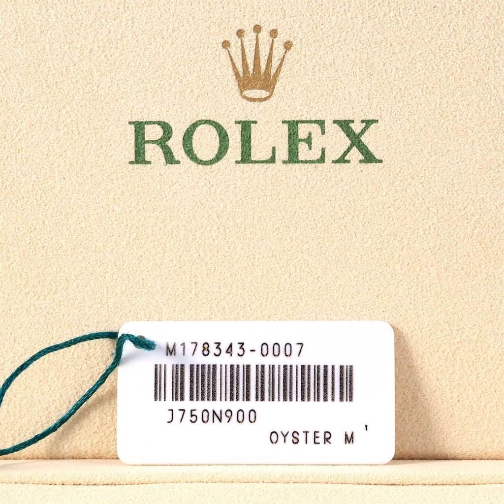 This image shows a Rolex tag with the model number "M178343-0007" and "OYSTER M" on a beige surface.