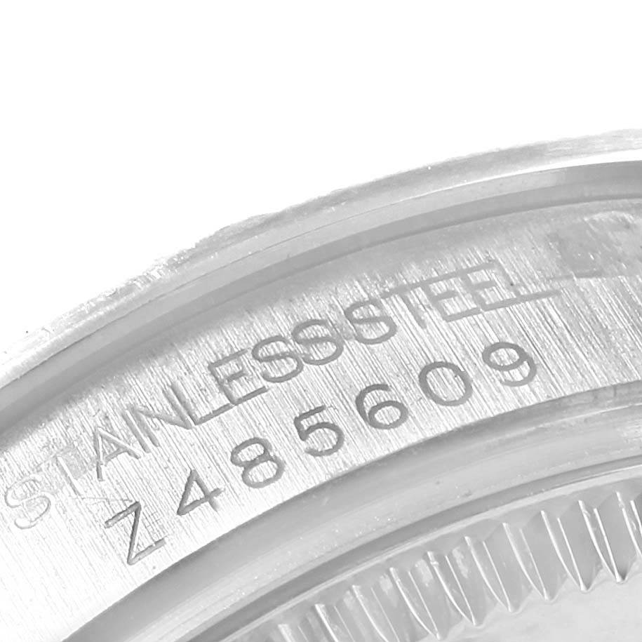 The image shows a close-up of the casing with serial number of the Mid-Size Rolex watch.