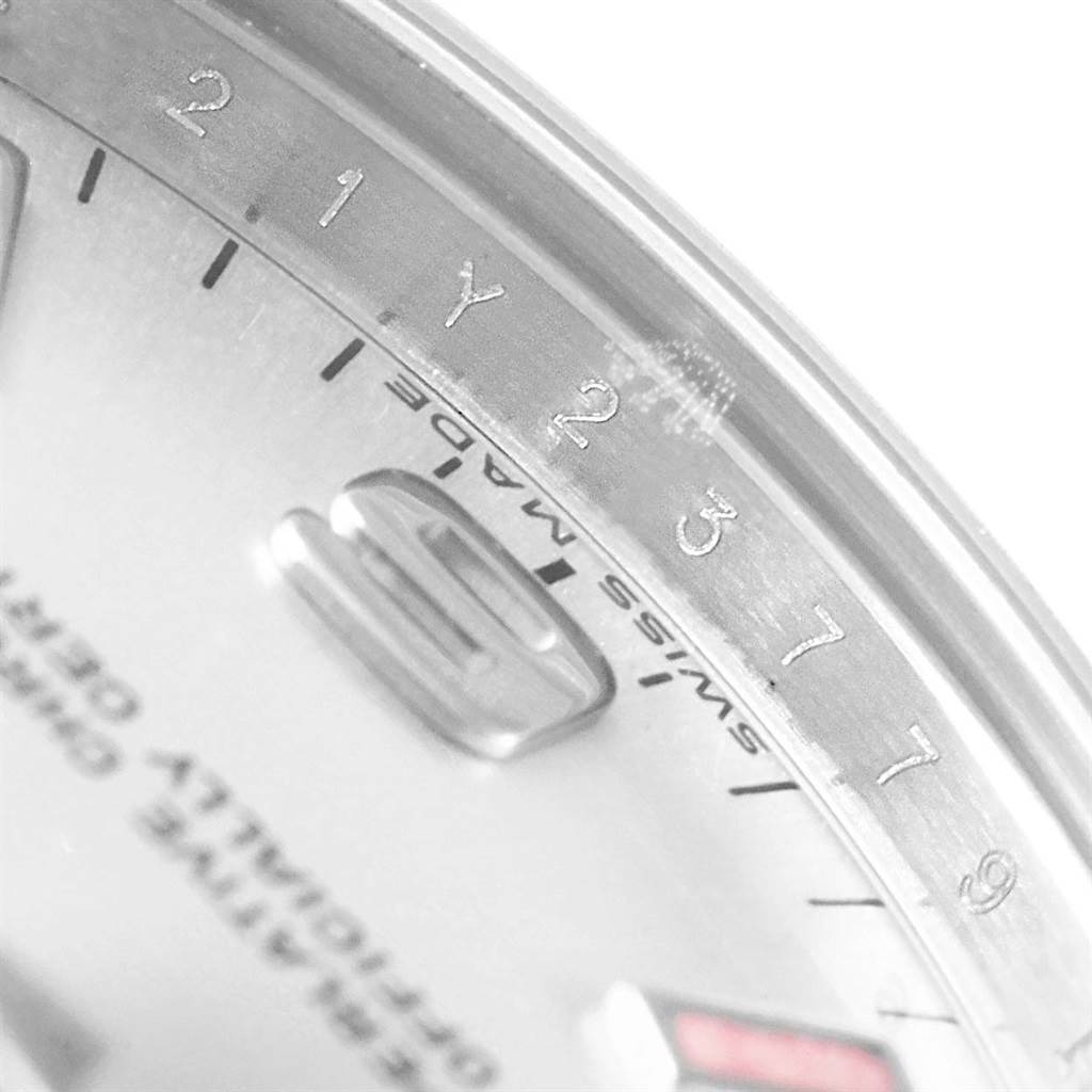 The image shows a close-up of the dial and bezel of a Mid-Size Rolex watch, focusing on the date window and part of the engraved bezel.