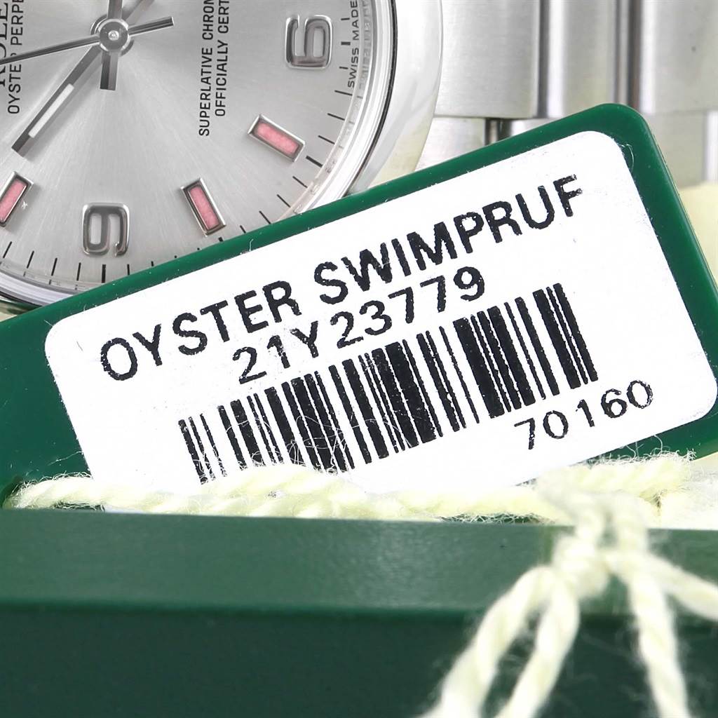 The image shows a partial view of a Rolex Mid-Size 177200 Women's Stainless Steel Silver Dial 177200 Women's Stainless Steel Silver Dial watch face and a label with the text "Oyster Swimpruf."