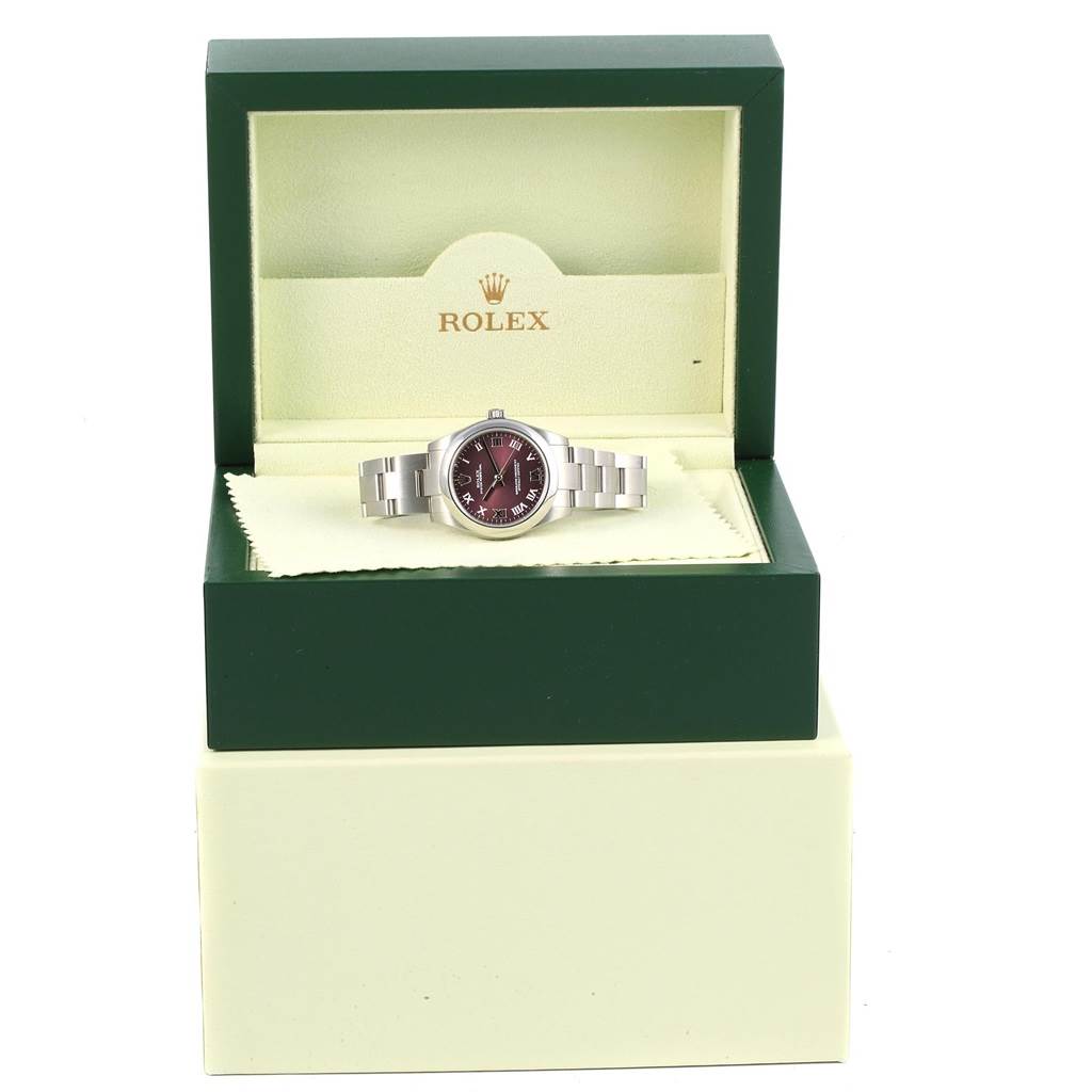 The Mid-Size Rolex watch is displayed front-on inside its branded presentation box, showing the dial and bracelet.