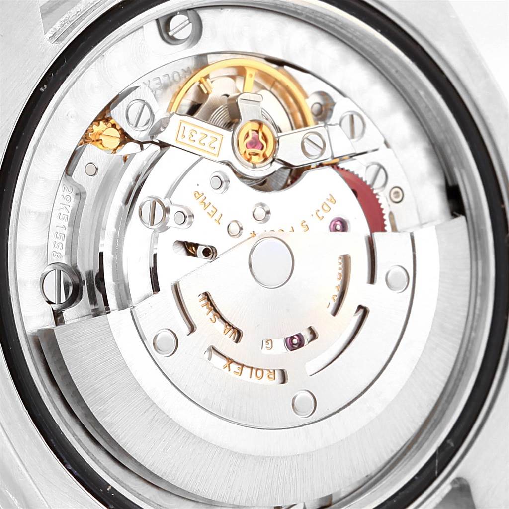 The image shows a close-up of the movement mechanism of a Rolex Mid-Size 177200 Men's Stainless Steel Burgundy Dial 177200 Men's Stainless Steel Burgundy Dial watch, highlighting the intricate inner components.