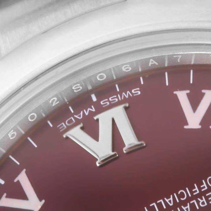 The image shows a close-up of the dial and bezel of a Mid-Size Rolex watch, focusing on the "VI" numeral and "Swiss Made" text.
