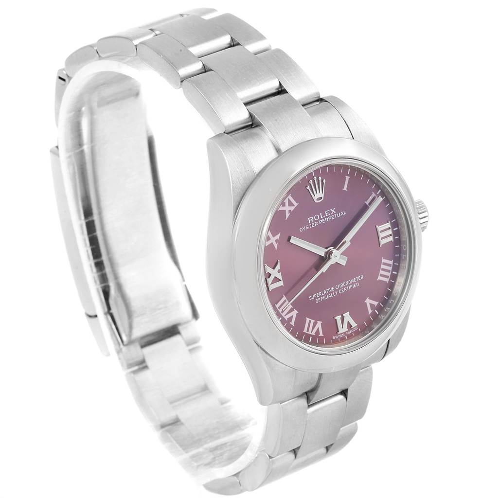The mid-size Rolex Oyster Perpetual watch is shown from a front-left angle, highlighting its dial, bezel, and bracelet.