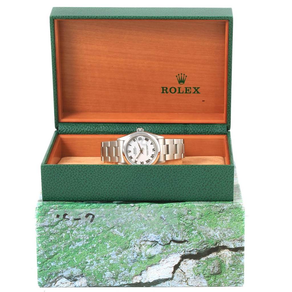 This is a front view of a Rolex Mid-Size 68240 Women's Stainless Steel White Dial 68240 Women's Stainless Steel White Dial watch displayed inside its green and orange Rolex box.