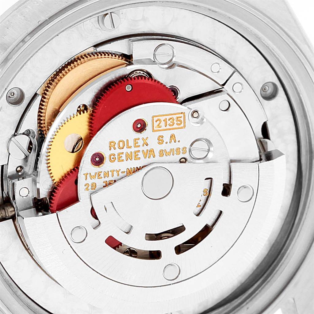 The image shows the intricate inner mechanism of a Rolex Mid-Size 68240 Women's Stainless Steel White Dial 68240 Women's Stainless Steel White Dial watch, specifically the movement parts.