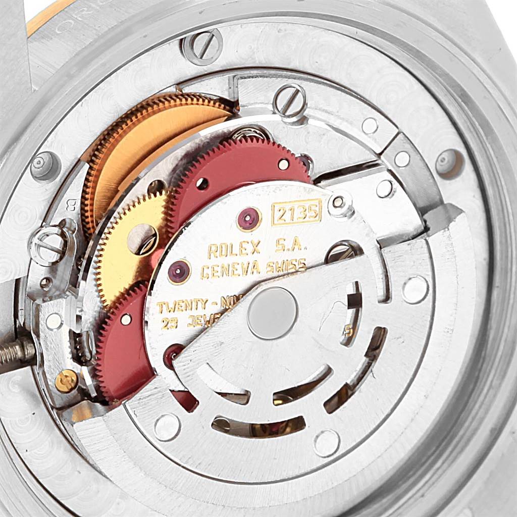 This image shows the internal mechanism of a Rolex Mid-Size 68273 Women's Steel and Gold (two tone) Black Dial 68273 Women's Steel and Gold (two tone) Black Dial model watch, highlighting gears and the rotor.