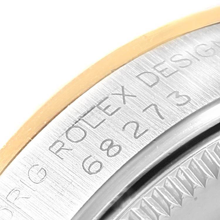 This close-up image shows the engraved case back of a Mid-Size Rolex watch.