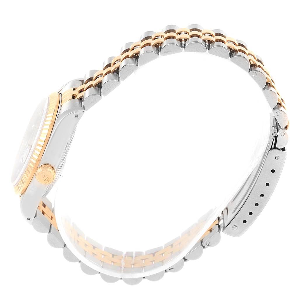 The image shows a side angle of a Rolex Mid-Size 68273 Women's Steel and Gold (two tone) Black Dial 68273 Women's Steel and Gold (two tone) Black Dial model watch, highlighting the crown, bezel, and two-tone bracelet.