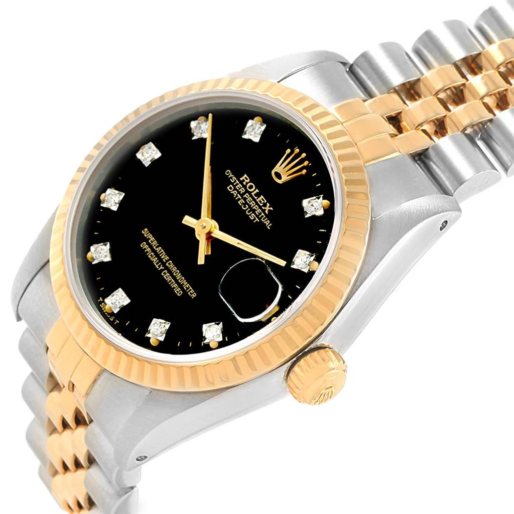 The image shows a close-up angle highlighting the black dial, gold bezel, and bracelet of the Mid-Size Rolex Datejust watch.