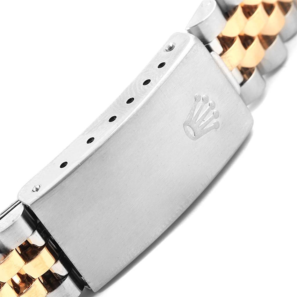 This image shows a close-up of the clasp and part of the bracelet of a Mid-Size Rolex watch.