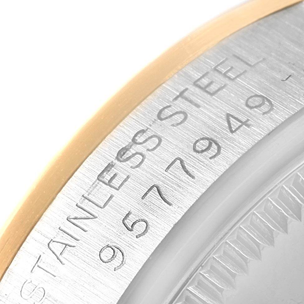 This close-up shows the serial number and "STAINLESS STEEL" engraving on the bezel of the Mid-Size Rolex watch.
