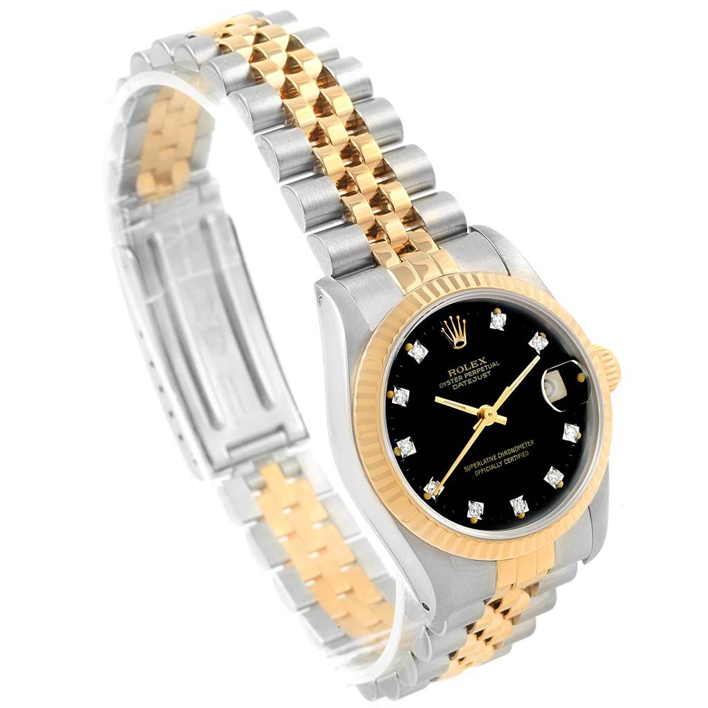 The image shows a Mid-Size Rolex watch at an angle highlighting its black dial, gold bezel, and two-tone metal bracelet.