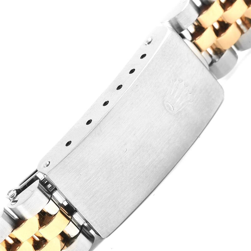 This image shows a close-up of the clasp on the bracelet of a Mid-Size Rolex watch.