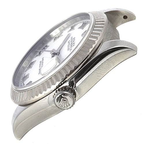 This image shows a side view of a Rolex Mid-Size 178274 Stainless Steel White Dial 178274 Stainless Steel White Dial model watch, highlighting the crown, bezel, and part of the case with lugs.