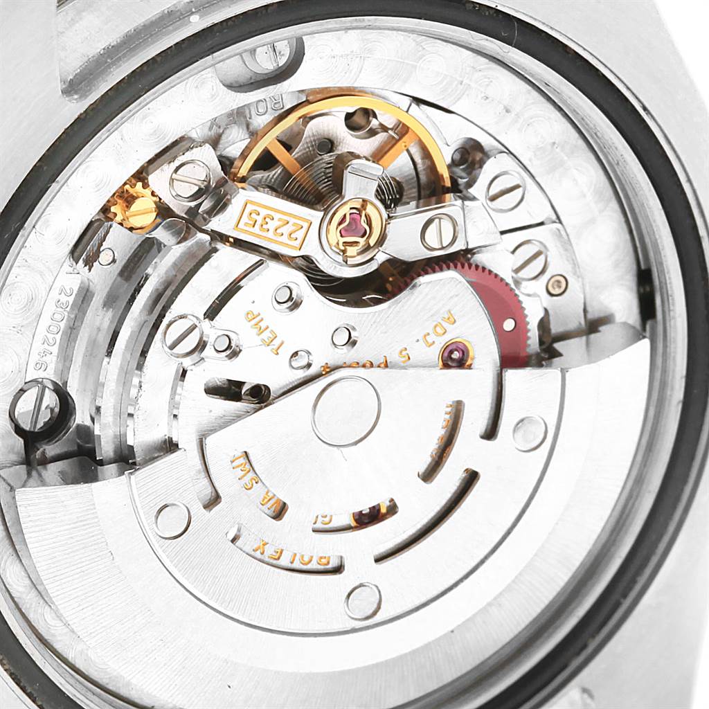 The image shows the internal mechanism and movement of a Mid-Size Rolex watch from a close-up, top-down angle.