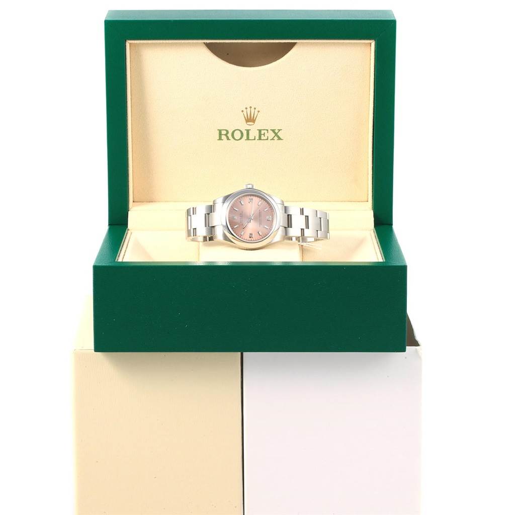 The Rolex Mid-Size 177200 Women's Stainless Steel Pink Dial 177200 Women's Stainless Steel Pink Dial model watch is displayed in an open green and cream Rolex box, showing the face and bracelet.