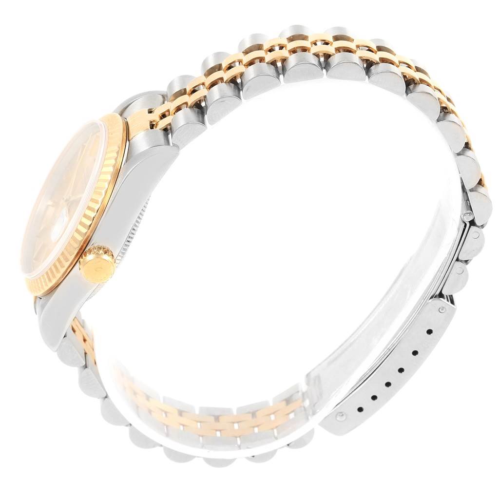 The image shows a side angle view of the Rolex Mid-Size 68273 Women's Steel and Gold (two tone) Champagne Dial 68273 Women's Steel and Gold (two tone) Champagne Dial model watch, highlighting its bracelet and crown.