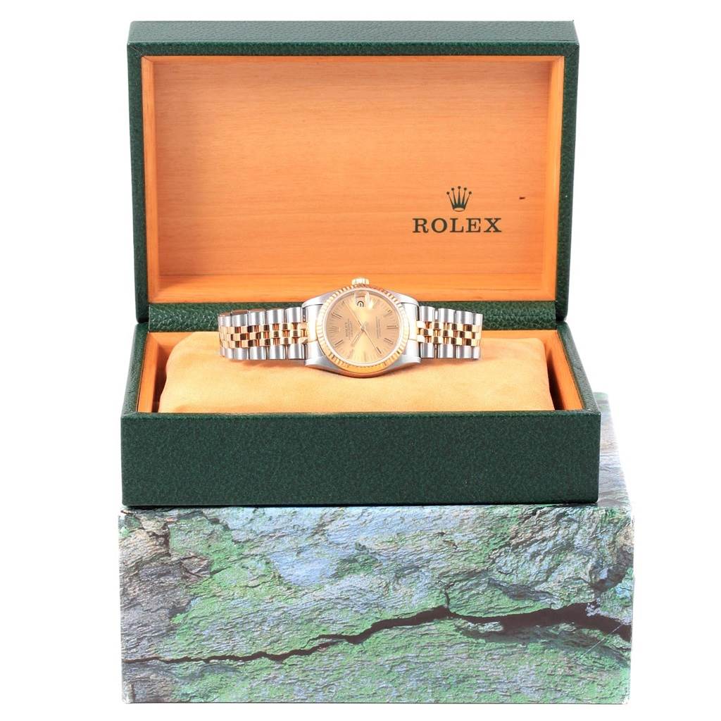 This is a front view of a Rolex Mid-Size 68273 Women's Steel and Gold (two tone) Champagne Dial 68273 Women's Steel and Gold (two tone) Champagne Dial watch displayed in an open green Rolex box with a wooden interior.