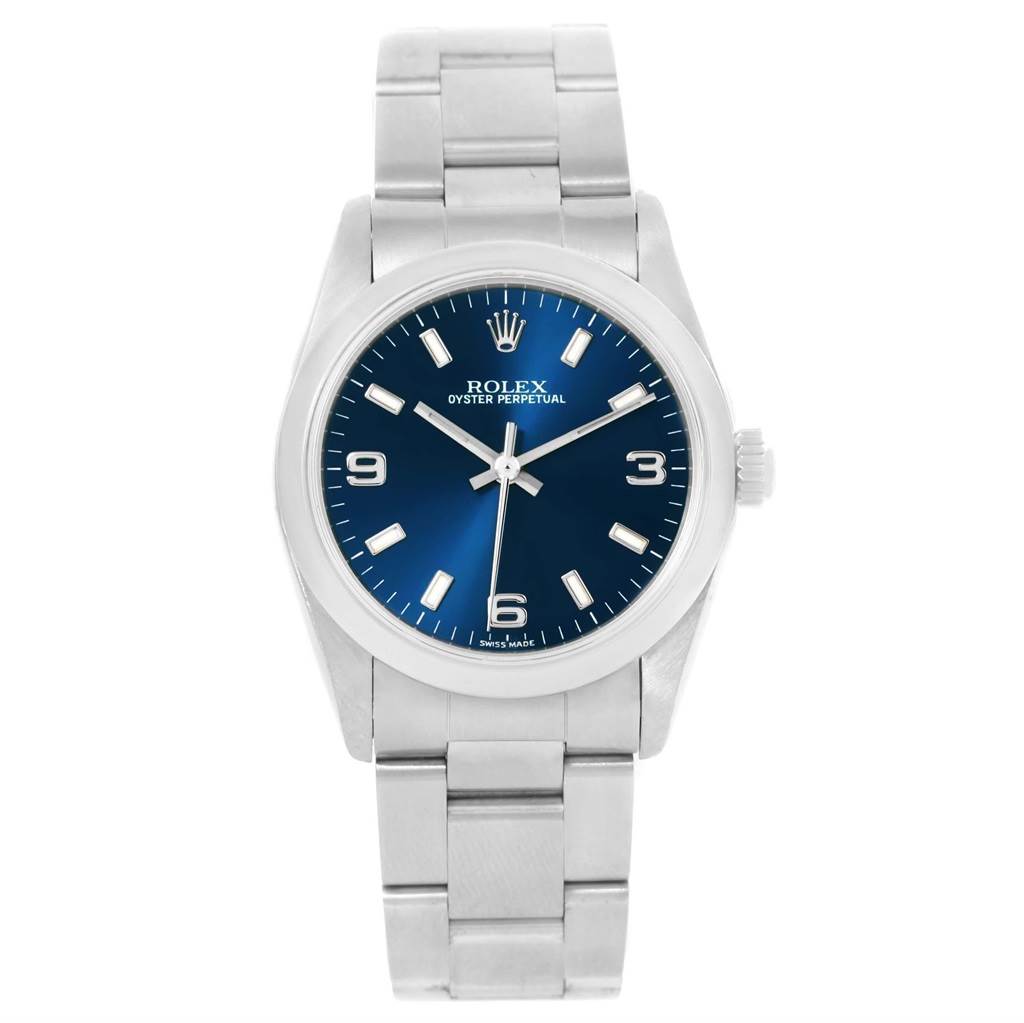 The Rolex Mid-Size 77080 Women's Stainless Steel Blue Dial 77080 Women's Stainless Steel Blue Dial watch is shown from a front angle, displaying its blue dial, silver markers, and stainless steel bracelet.