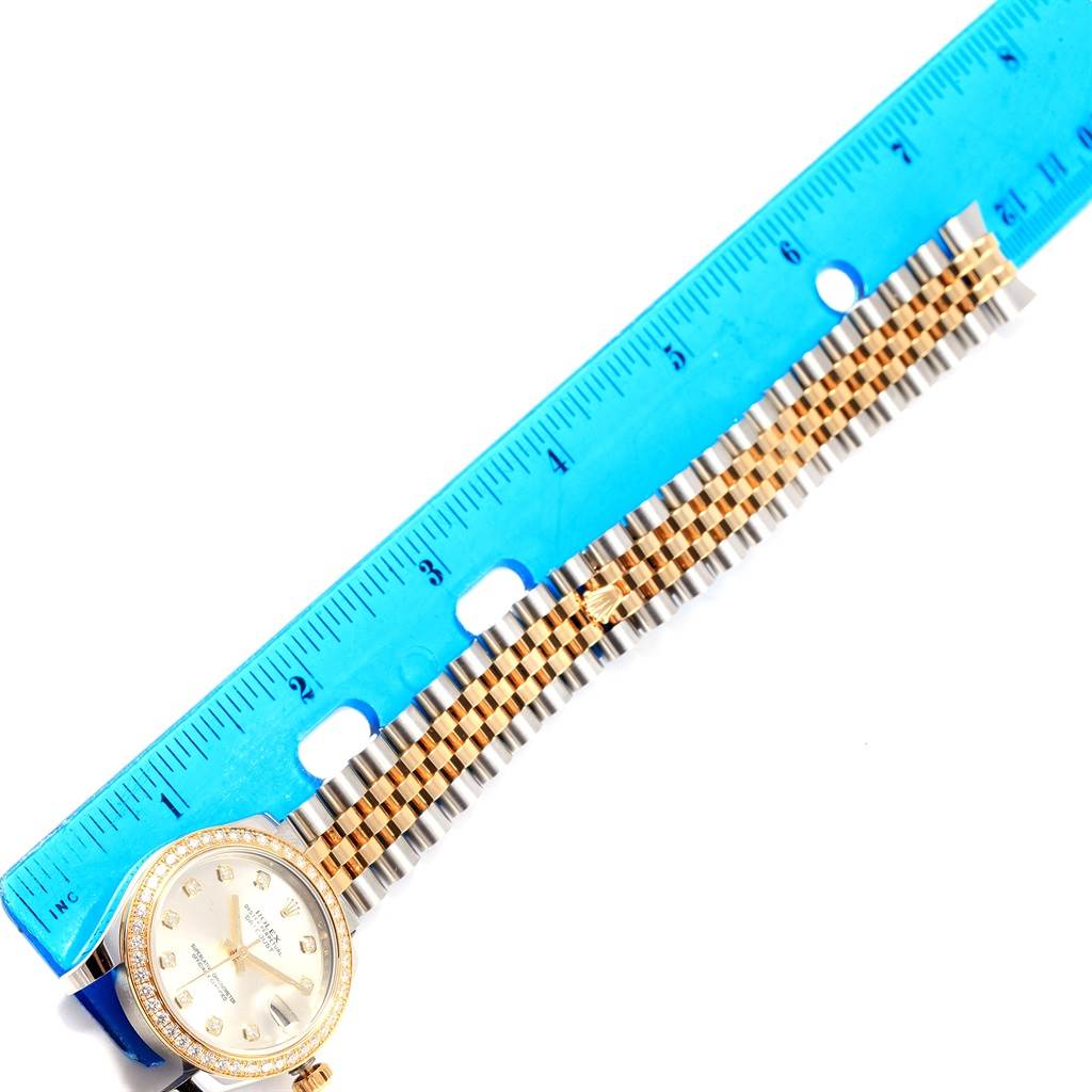 The image shows the Rolex Mid-Size 178383 Women's Steel and Gold (two tone) Silver Dial 178383 Women's Steel and Gold (two tone) Silver Dial watch face and band next to a blue ruler for scale.