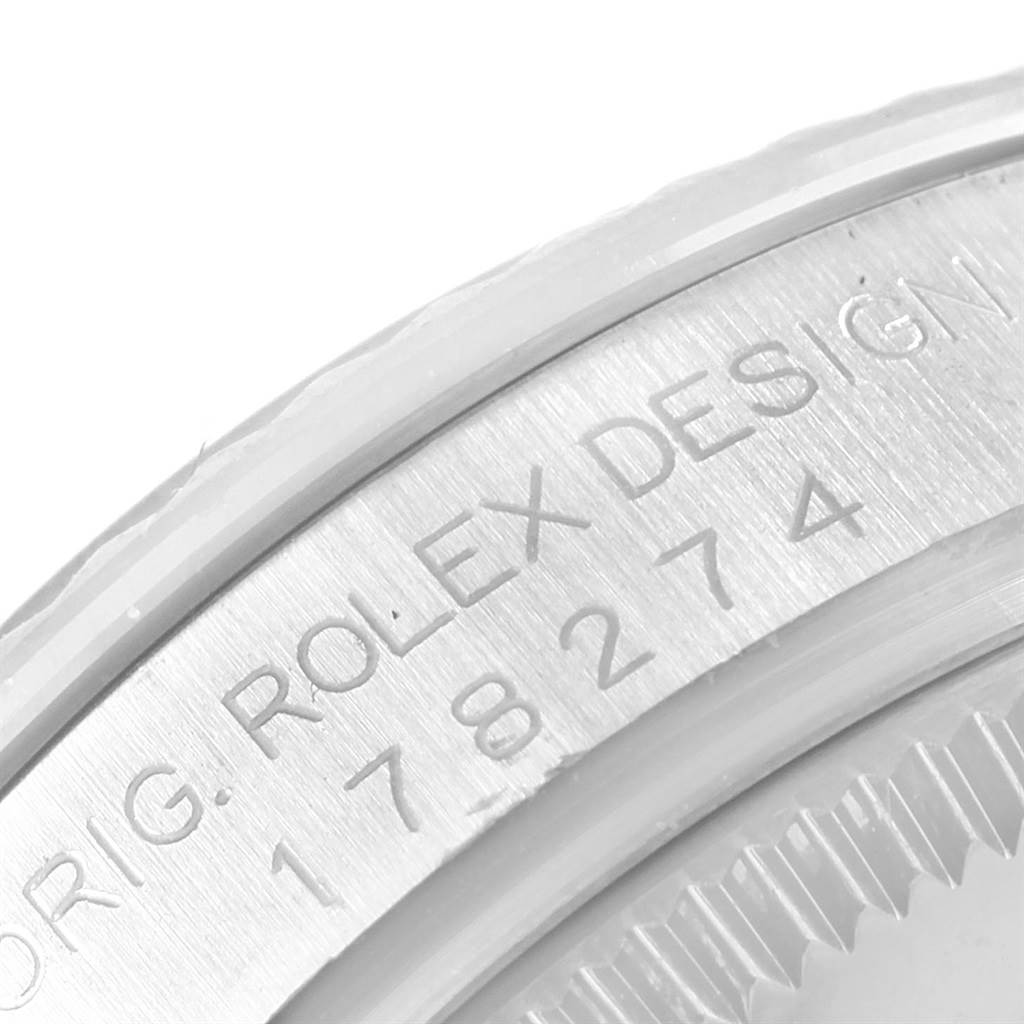 The image shows a close-up of the engravings on the bezel of a Rolex Mid-Size 178274 Men's Stainless Steel White Dial 178274 Men's Stainless Steel White Dial model watch.