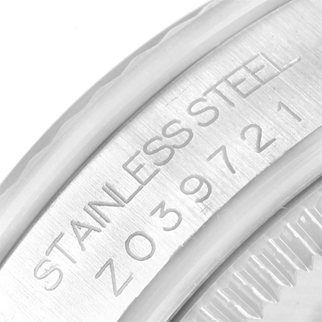 This close-up image shows the stainless steel engraving and serial number on a Rolex Mid-Size 178274 Men's Stainless Steel White Dial 178274 Men's Stainless Steel White Dial watch case.