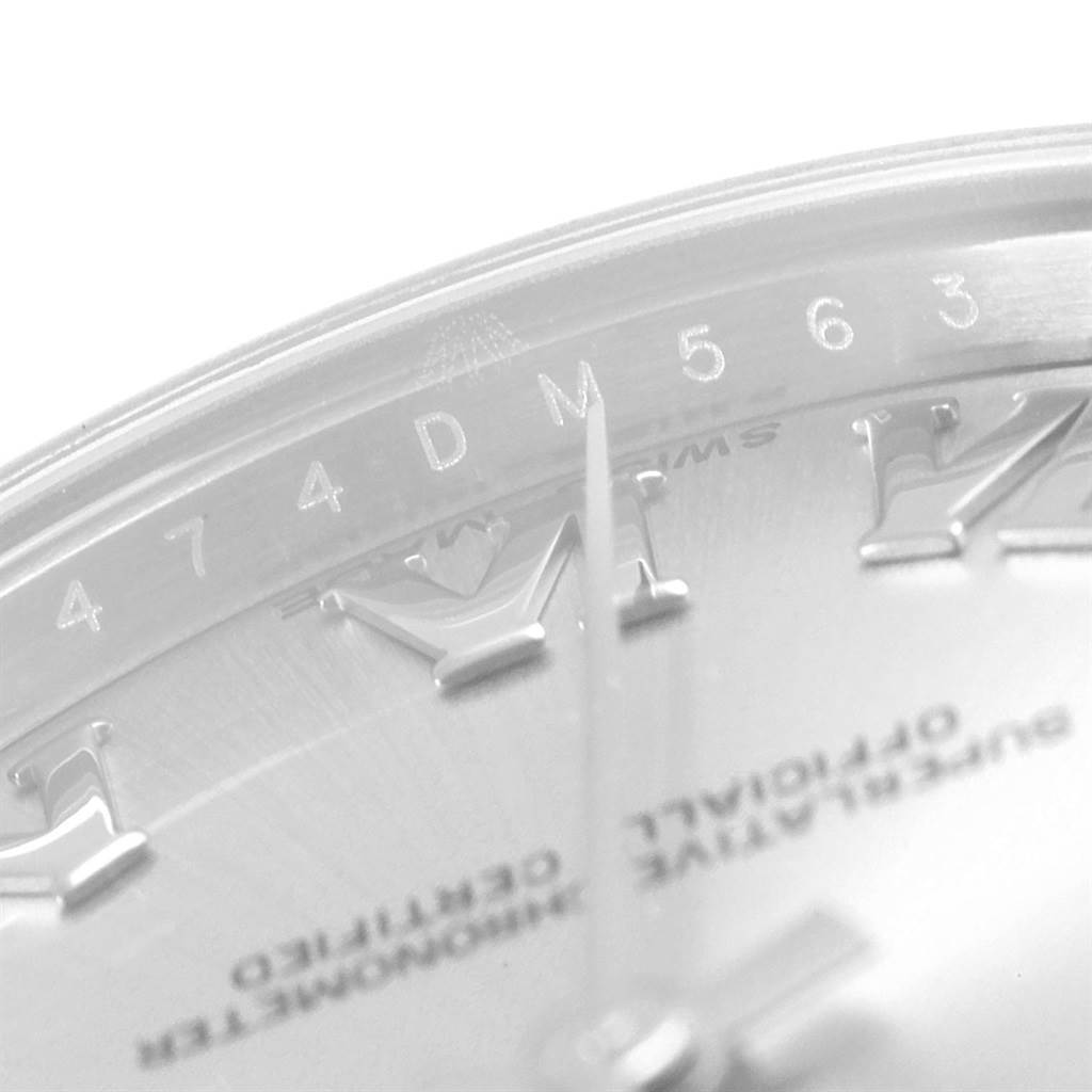 This close-up image of the Rolex Mid-Size 178274 Women's Stainless Steel Silver Dial 178274 Women's Stainless Steel Silver Dial watch shows the dial with roman numerals and the serial number on the inner bezel.
