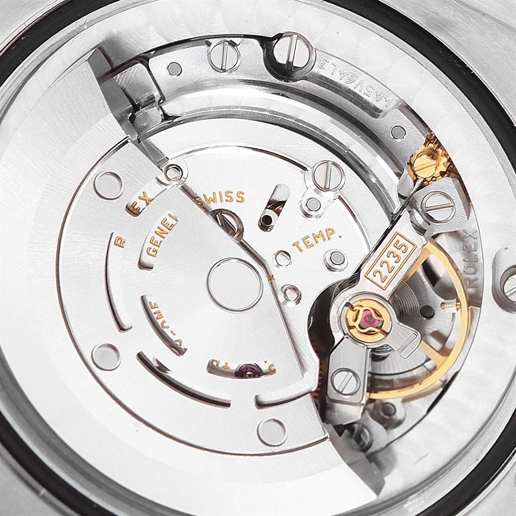 The image shows a close-up of the internal mechanical movement of a mid-size Rolex watch, highlighting intricate parts and gears.