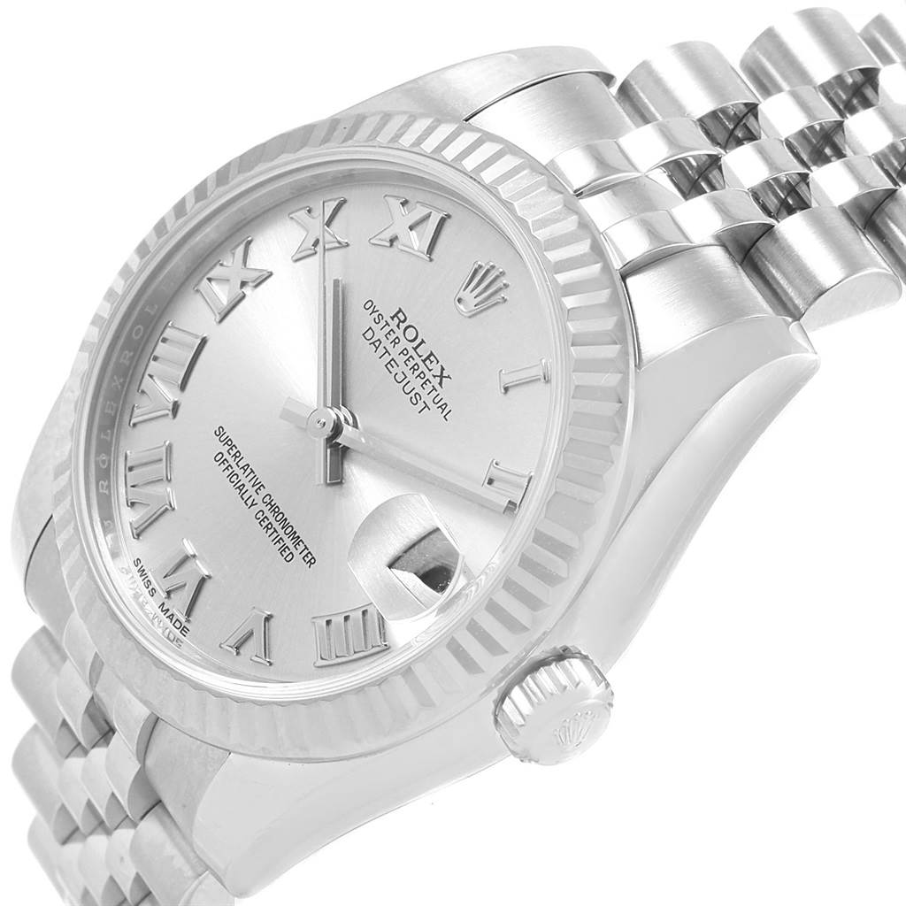 This is a close-up angle of the Rolex Mid-Size 178274 Women's Stainless Steel Silver Dial 178274 Women's Stainless Steel Silver Dial Datejust watch, showing the Roman numeral dial, fluted bezel, crown, and part of the bracelet.