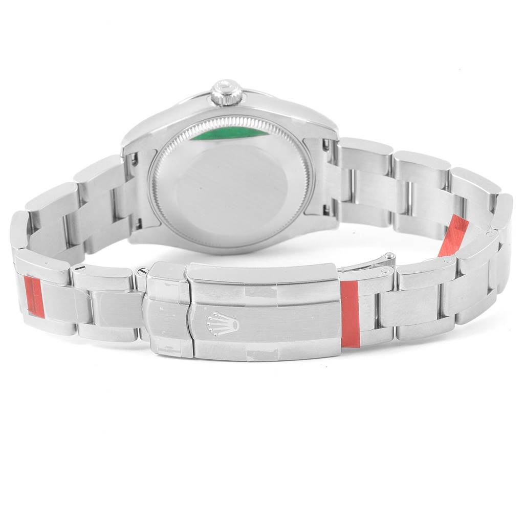 The image shows the back of a Mid-Size Rolex watch, featuring the case back and metal bracelet with a clasp.