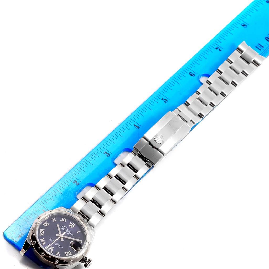 The image shows a Rolex Mid-Size 178344 Women's Stainless Steel Purple Dial 178344 Women's Stainless Steel Purple Dial watch laid flat with its bracelet next to a blue ruler for scale.