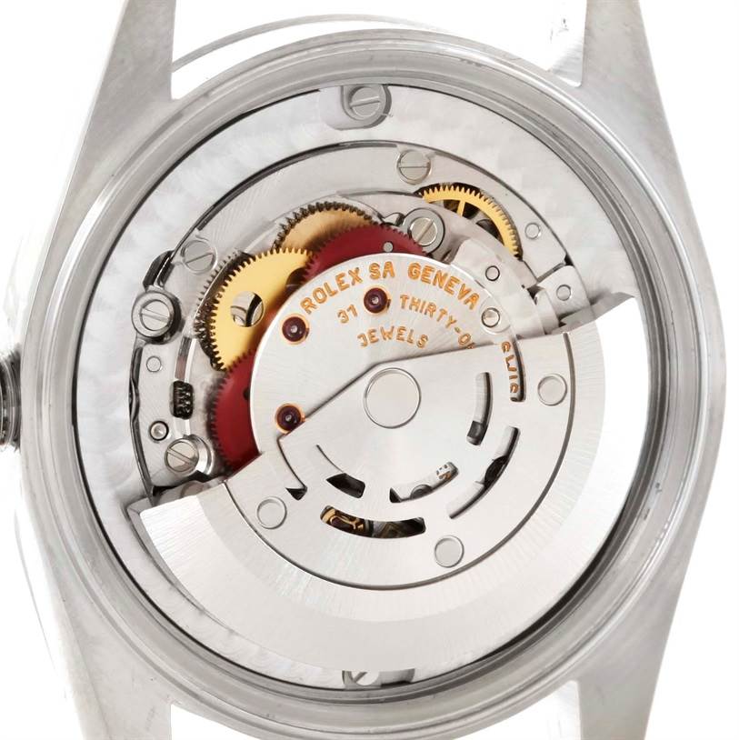 This image shows the back view of a Mid-Size Rolex watch, displaying its intricate internal mechanism and parts.