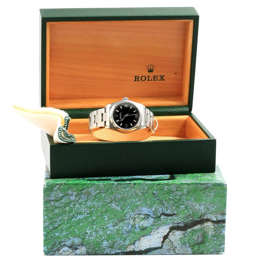 The Rolex Mid-Size 77080 Women's Stainless Steel Black Dial 77080 Women's Stainless Steel Black Dial model watch is shown at a front angle, displayed inside an open watch box.