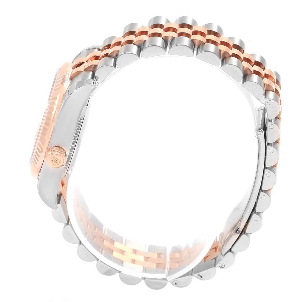 The image shows a side profile of a Rolex Mid-Size 178271 Women's Steel and Gold (two tone) Pink Dial 178271 Women's Steel and Gold (two tone) Pink Dial watch, highlighting the crown, bezel, and jubilee bracelet.