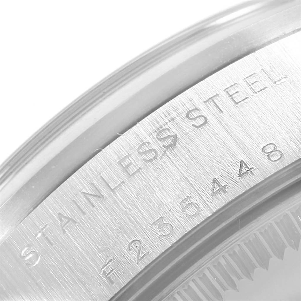 The image shows a close-up of the serial number and "STAINLESS STEEL" engraving on the Rolex 78240 Men's Stainless Steel Pink Dial 78240 Men's Stainless Steel Pink Dial Datejust 31 Midsize Salmon Roman Dial Ladies Watch 78240.