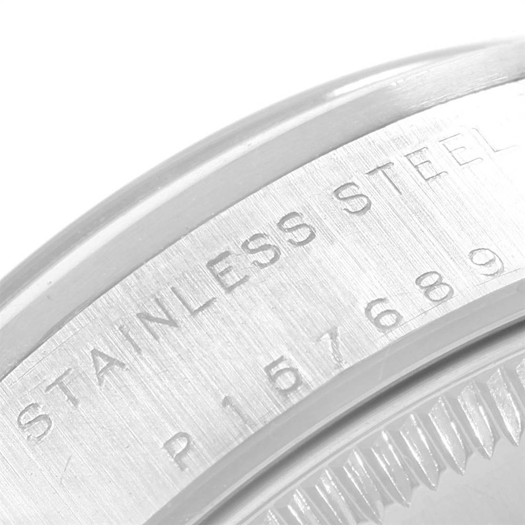 This image shows a close-up of the stainless steel case back edge and serial number of the Rolex Mid-Size 78240 Women's Stainless Steel Pink Dial 78240 Women's Stainless Steel Pink Dial model watch.