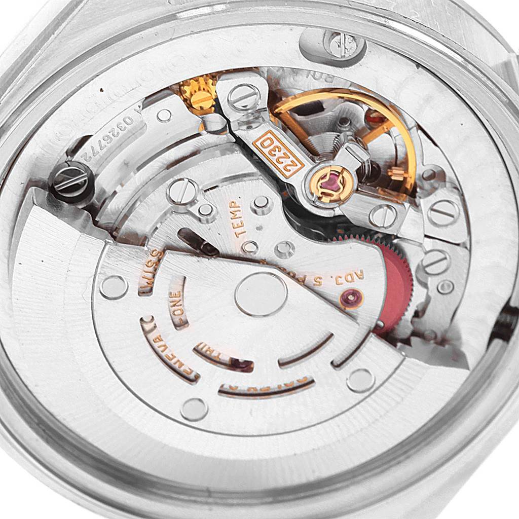 The image shows a close-up view of the movement mechanism of a Mid-Size Rolex watch from the back.