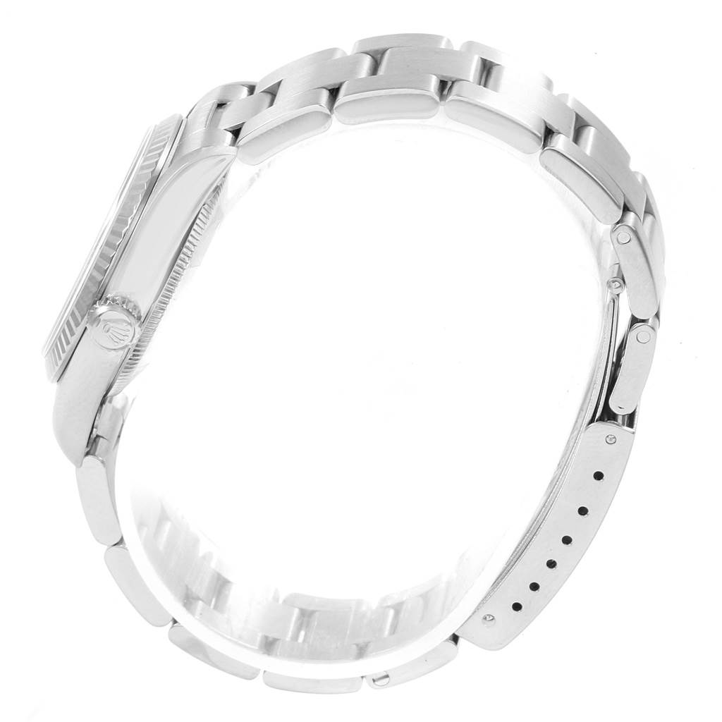 The image shows a side view of a Rolex Mid-Size 77014 Women's Stainless Steel Blue Dial 77014 Women's Stainless Steel Blue Dial watch, highlighting the case, bracelet, clasp, and crown.