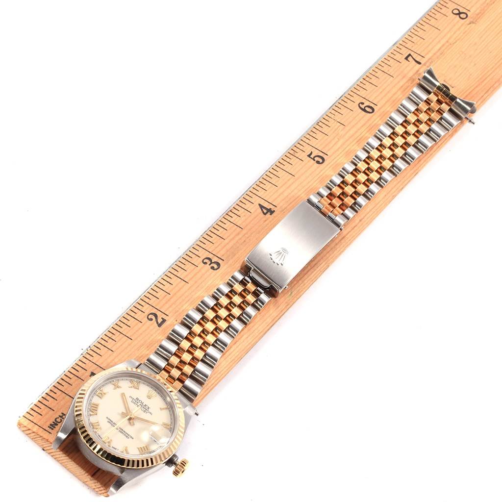 The image shows a Rolex Mid-Size 68273 Women's Steel and Gold (two tone) Beige Dial 68273 Women's Steel and Gold (two tone) Beige Dial watch laying flat next to a ruler, displaying its face, two-tone bracelet, and clasp.