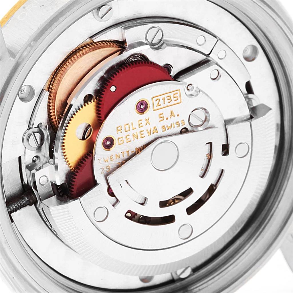 This image shows the internal mechanisms of a Rolex Mid-Size 68273 Women's Steel and Gold (two tone) Beige Dial 68273 Women's Steel and Gold (two tone) Beige Dial watch model 2135 at a close-up angle.