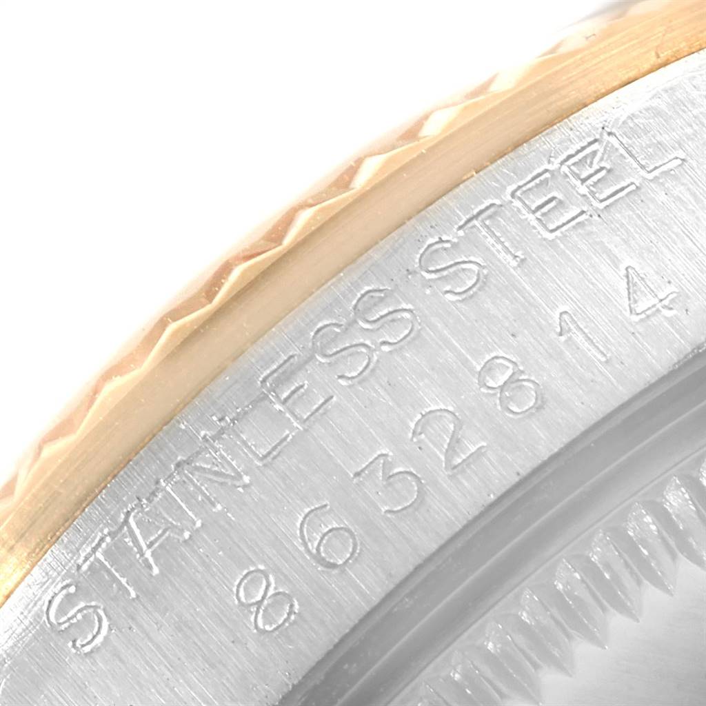 This close-up image shows the stainless steel and gold bezel with engravings of a Mid-Size Rolex watch.