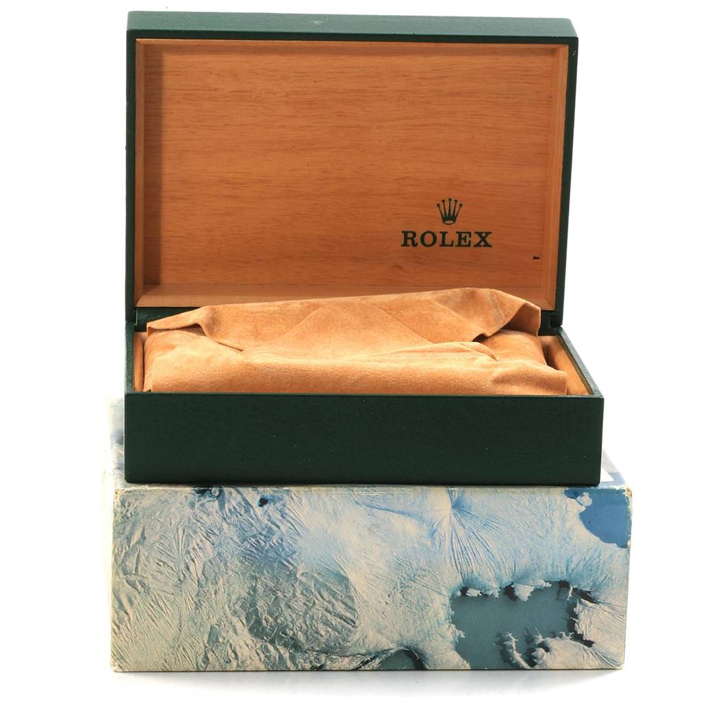 The image shows an open Rolex watch box and partly opened exterior box for a mid-size model, with the Rolex logo inside the lid.
