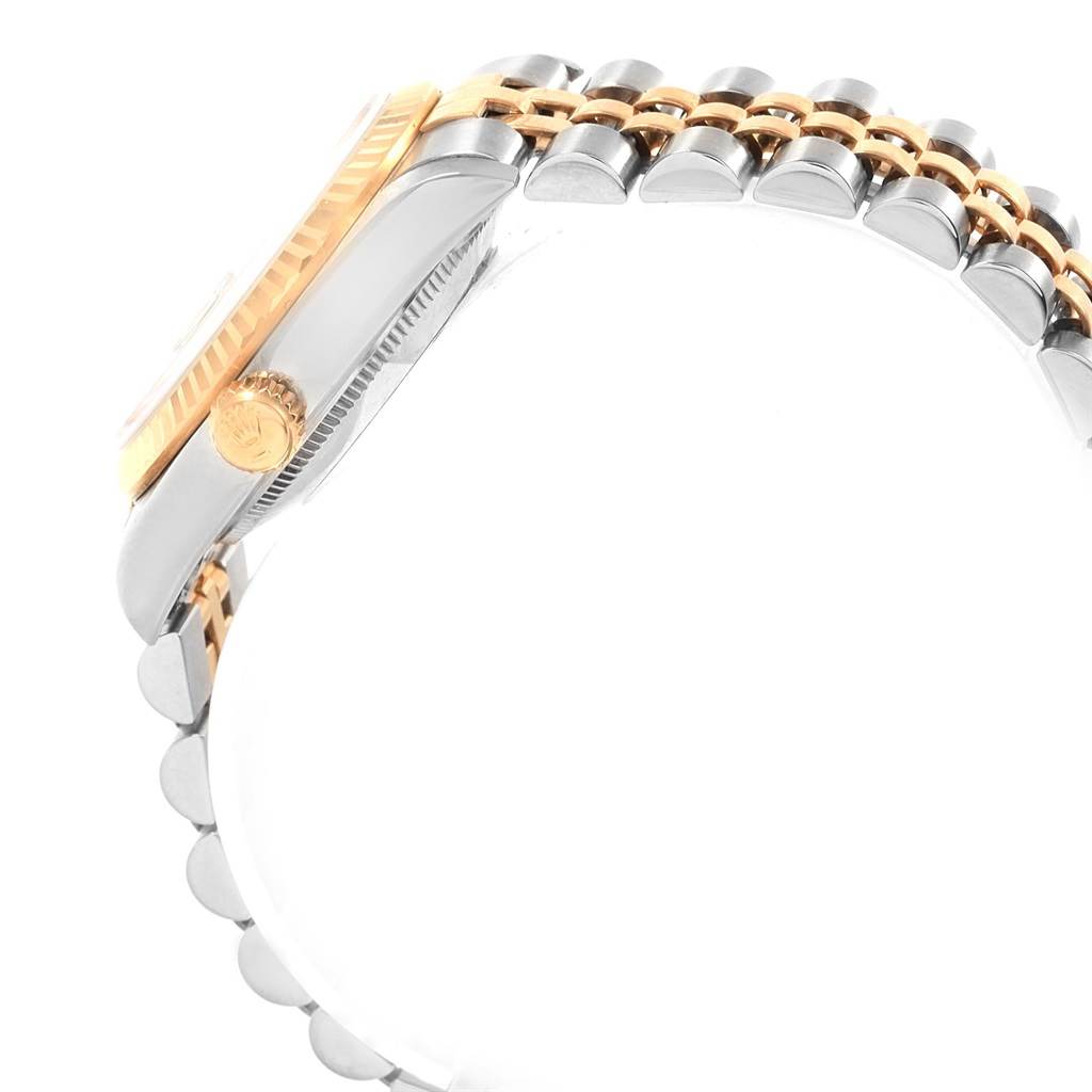 The image shows a side profile of the Rolex Mid-Size 68273 Women's Steel and Gold (two tone) White Dial 68273 Women's Steel and Gold (two tone) White Dial watch highlighting the crown and a two-tone bracelet.